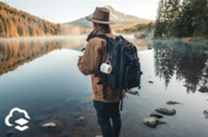 Photo of backpacker near lake with logo in the corner Photo of backpacker near lake with logo in the corner